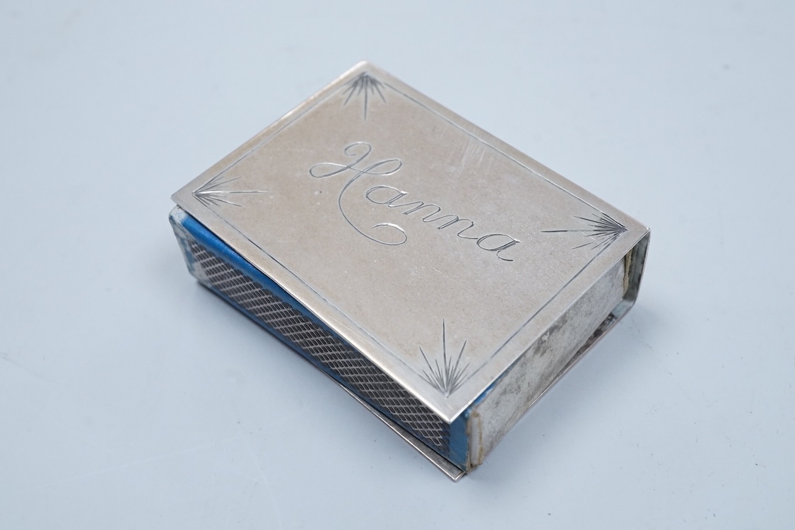 A George V engraved silver cigarette case, Birmingham, 1930, 82mm, a similar silver vesta case, London, 1913 and two silver matchbox sleeves.